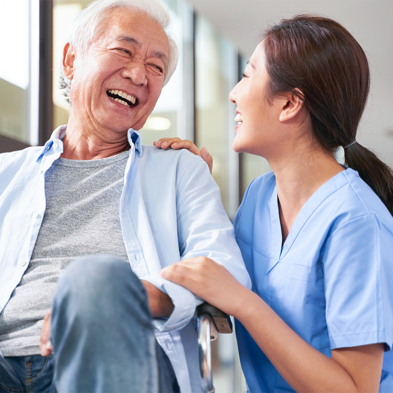 Nurse and older patient sharing a laugh