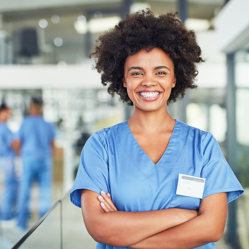 a beautiful smiling nurse, dressed in blue