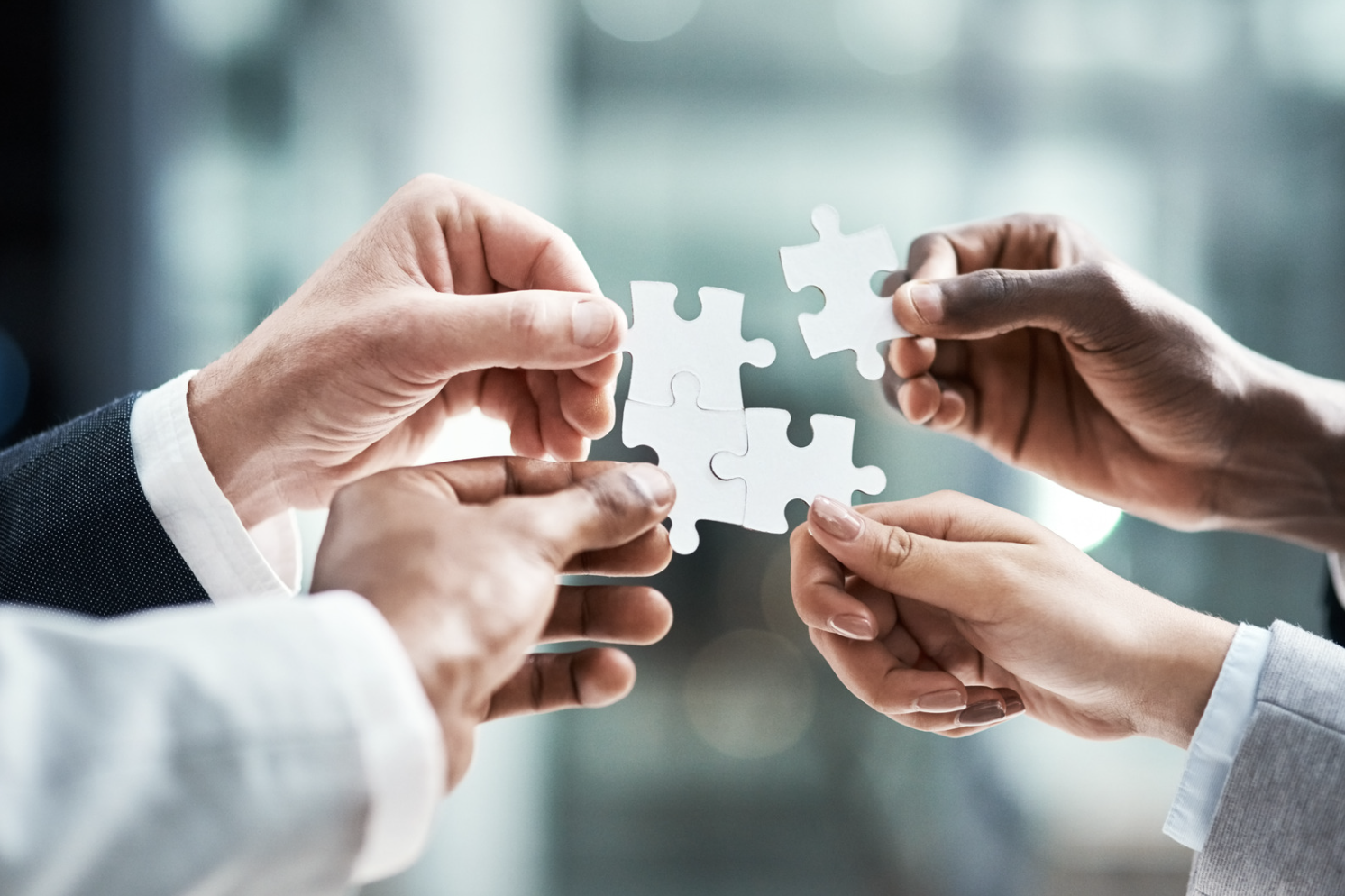 Hands holding puzzle pieces